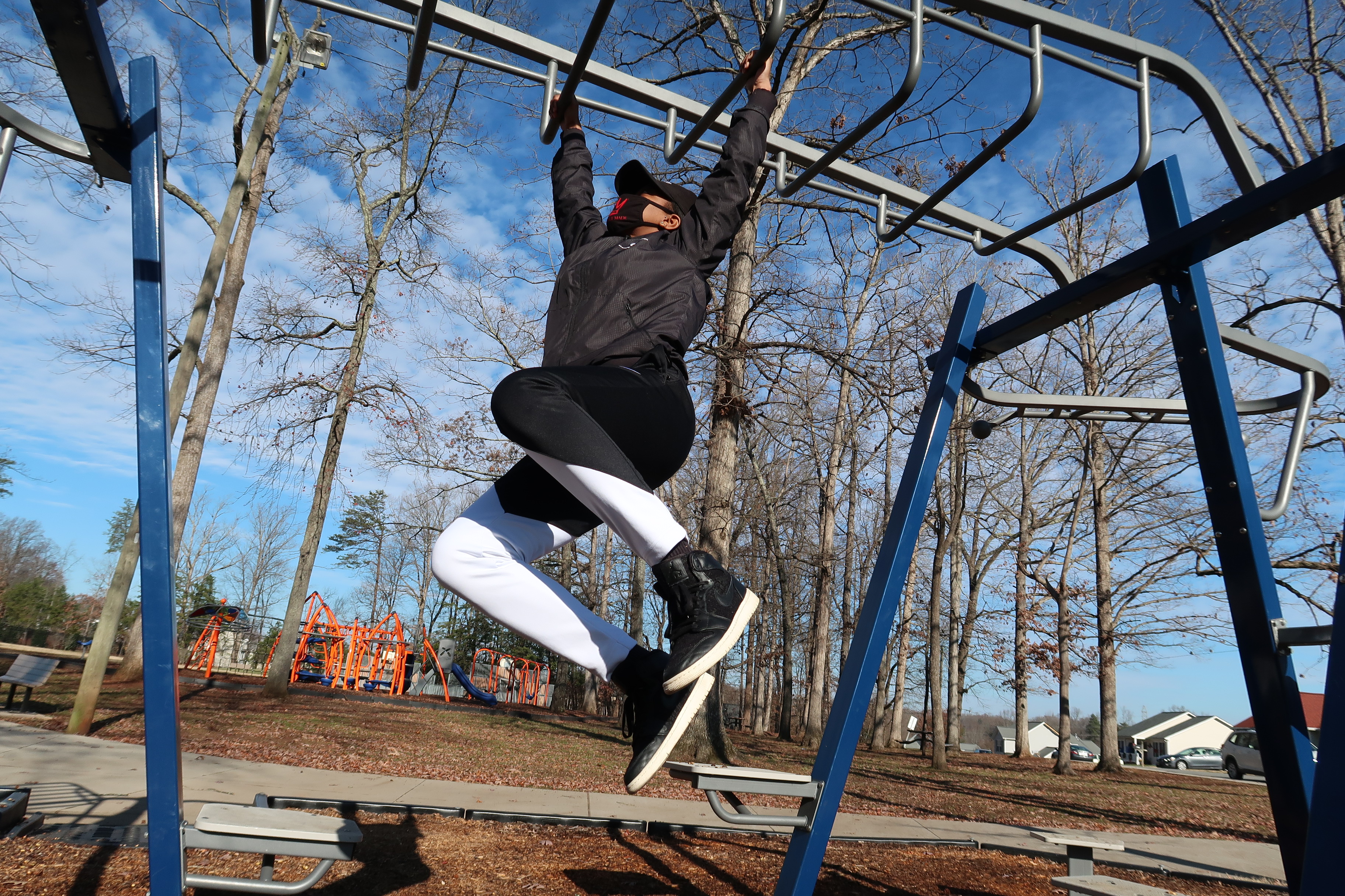 Man climbing on monkey bars